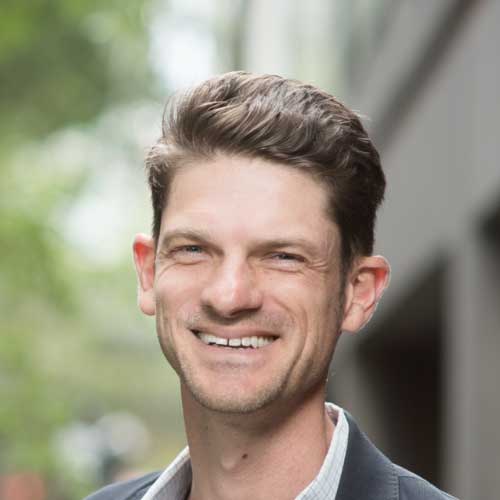 Headshot of Paul smiling