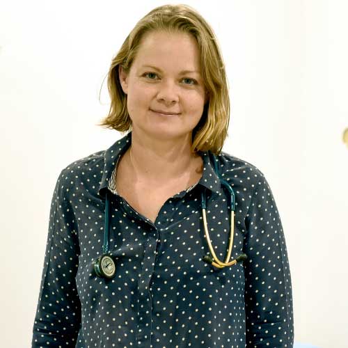 Headshot of Emma smiling with stethoscope around her neck