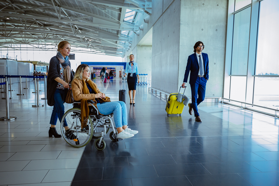 Woman pushing another woman in a wheelchair at the airport